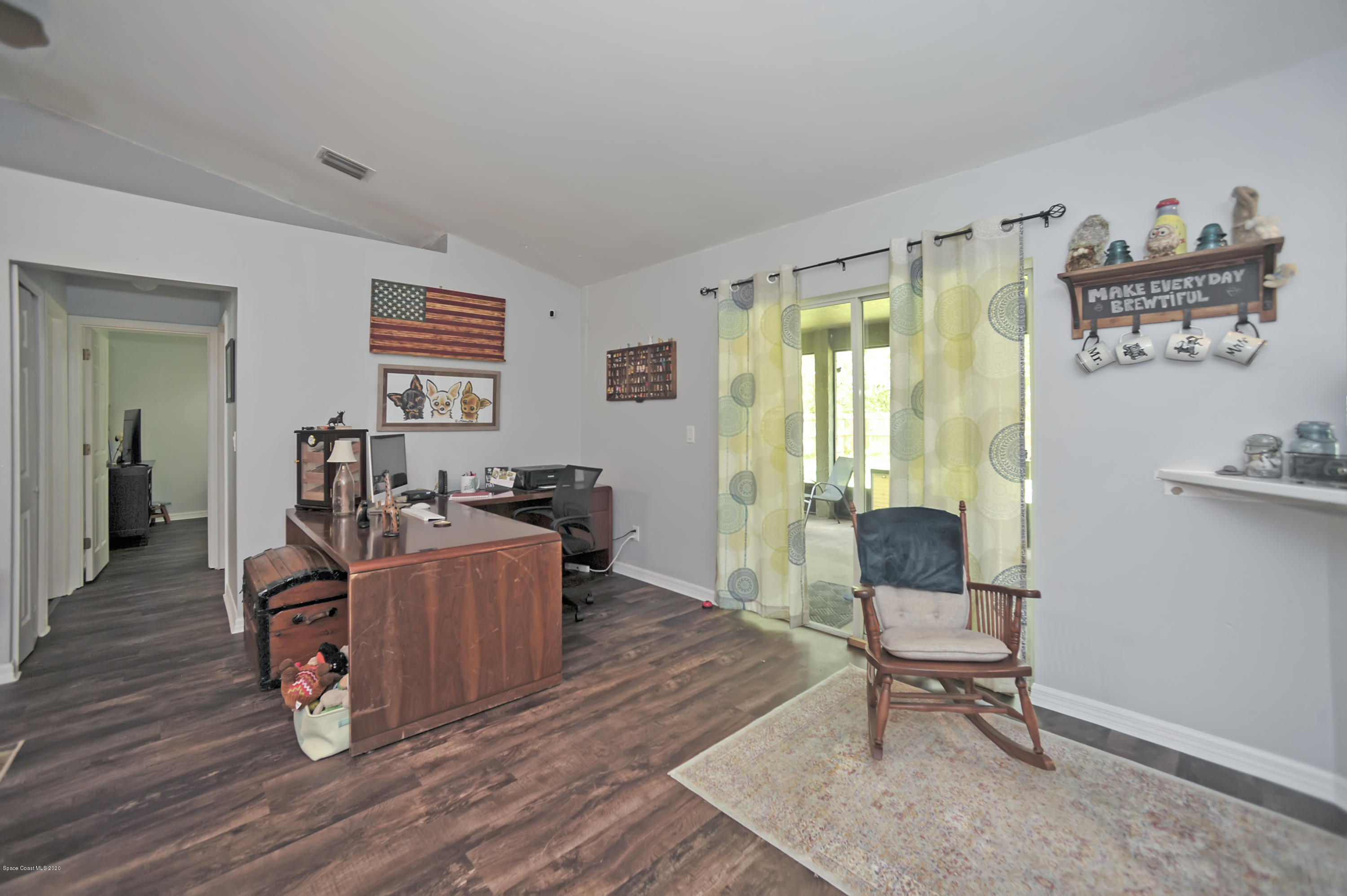 877 Walpole Road Southwest Palm Bay, FL 32908 - Photo 9 of 27 a living room with furniture and a wooden floor