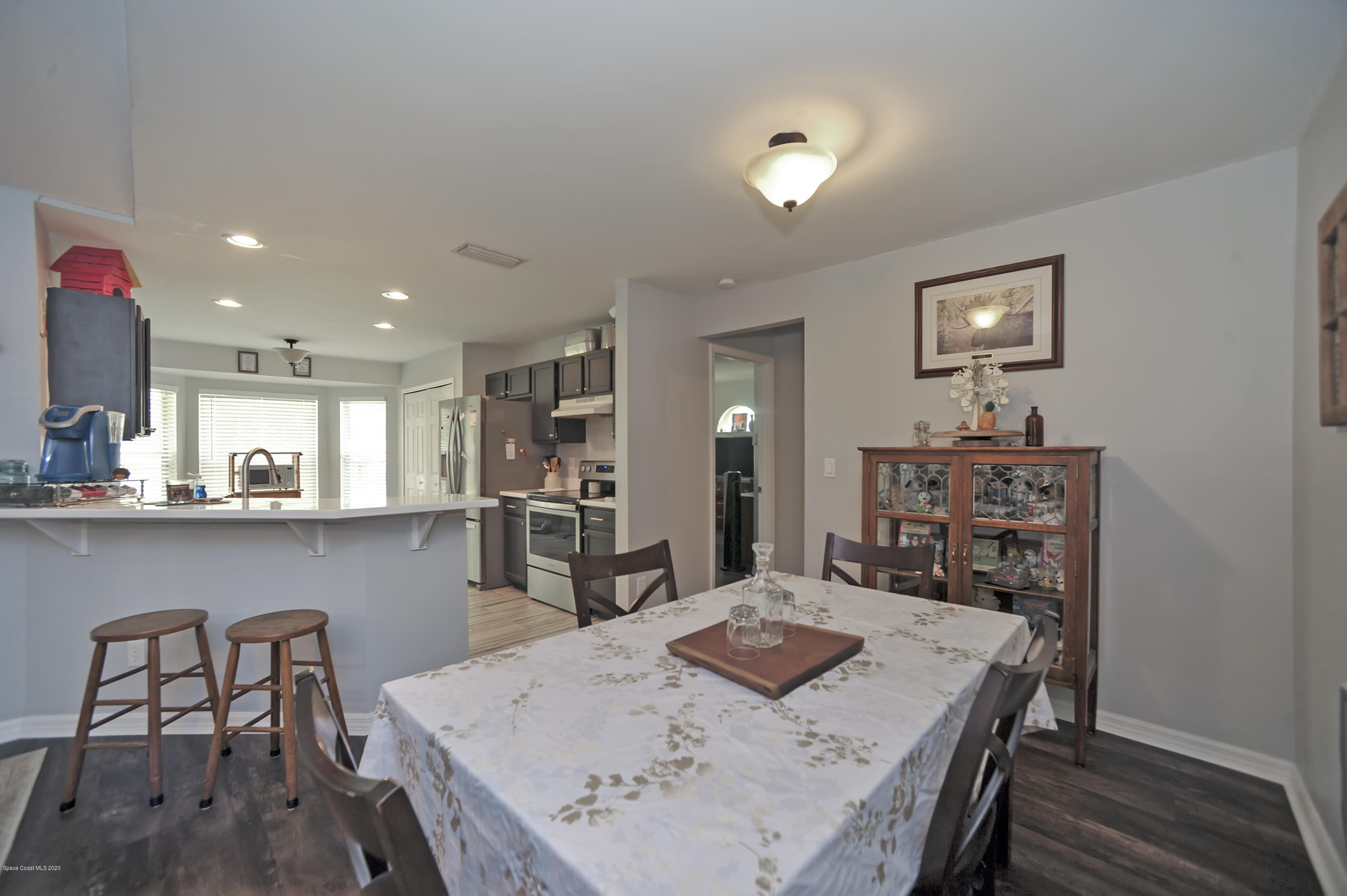 877 Walpole Road Southwest Palm Bay, FL 32908 - Photo 10 of 27 a view of a dining room with furniture and wooden floor