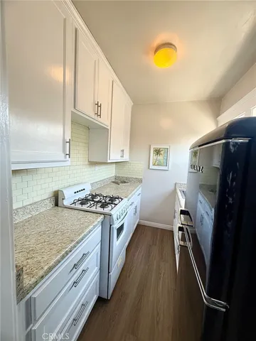 a kitchen with a stove a refrigerator and a sink
