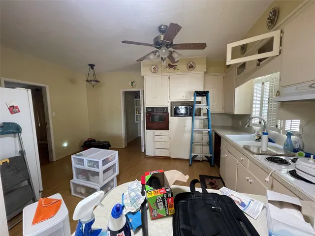 a kitchen with stainless steel appliances a sink a stove a refrigerator and cabinets