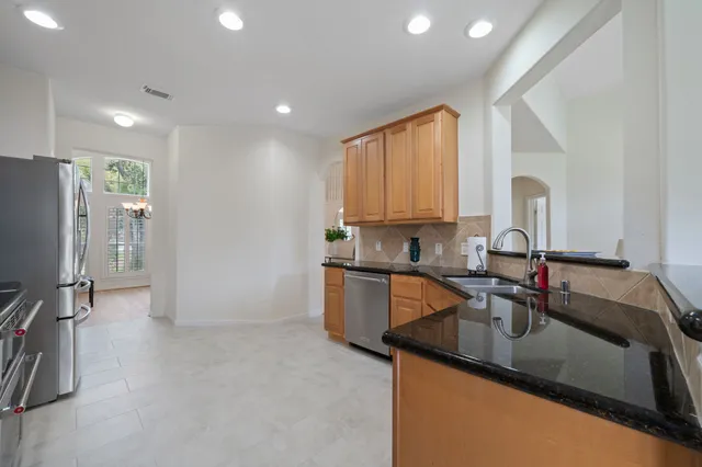 a kitchen with a sink appliances and cabinets