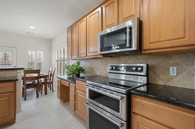 a kitchen with a stove and a microwave