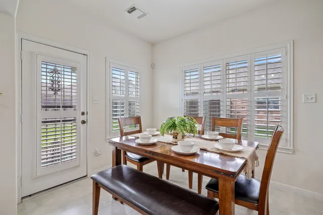 a view of a dining room with furniture and windows