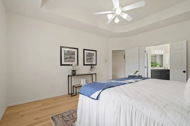 a spacious bedroom with a bed and a chandelier