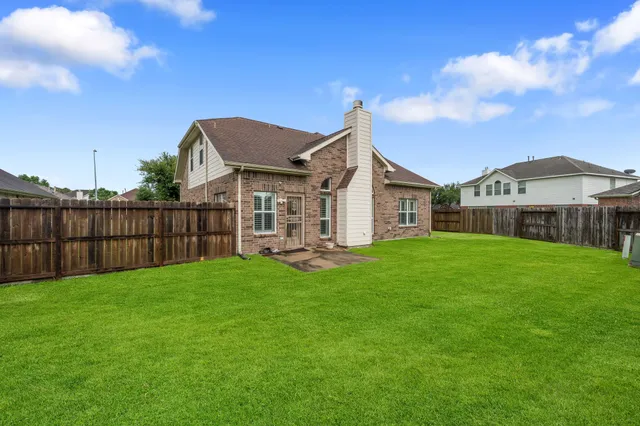a view of a house with a yard and sitting area