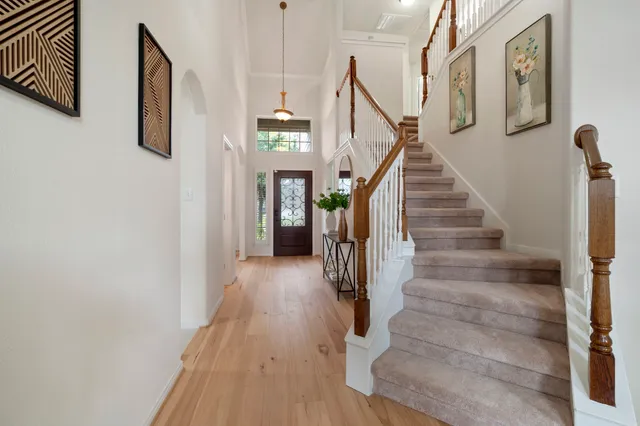 a view of entryway and hall with wooden floor