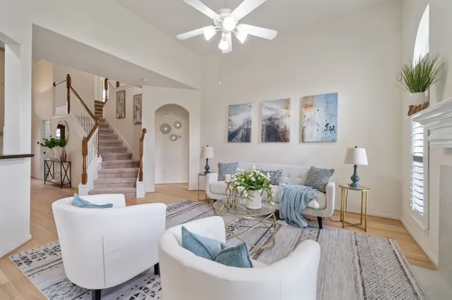 a living room with furniture and a chandelier