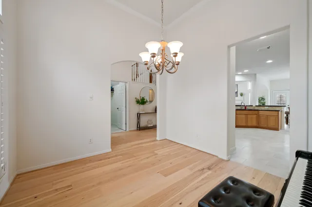 a view of a room with wooden floor and chandelier