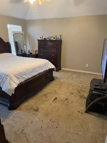 a bedroom with a bed and a mirror