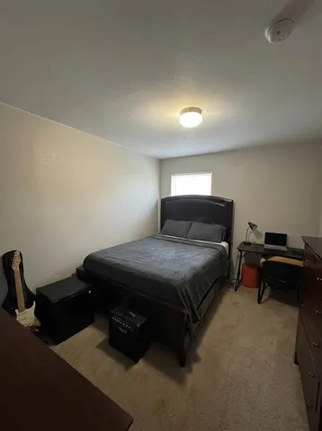 a bedroom with a bed and a chair