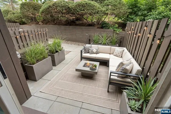 a view of patio with furniture and a garden