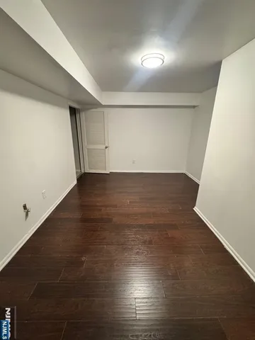 an empty room with wooden floor