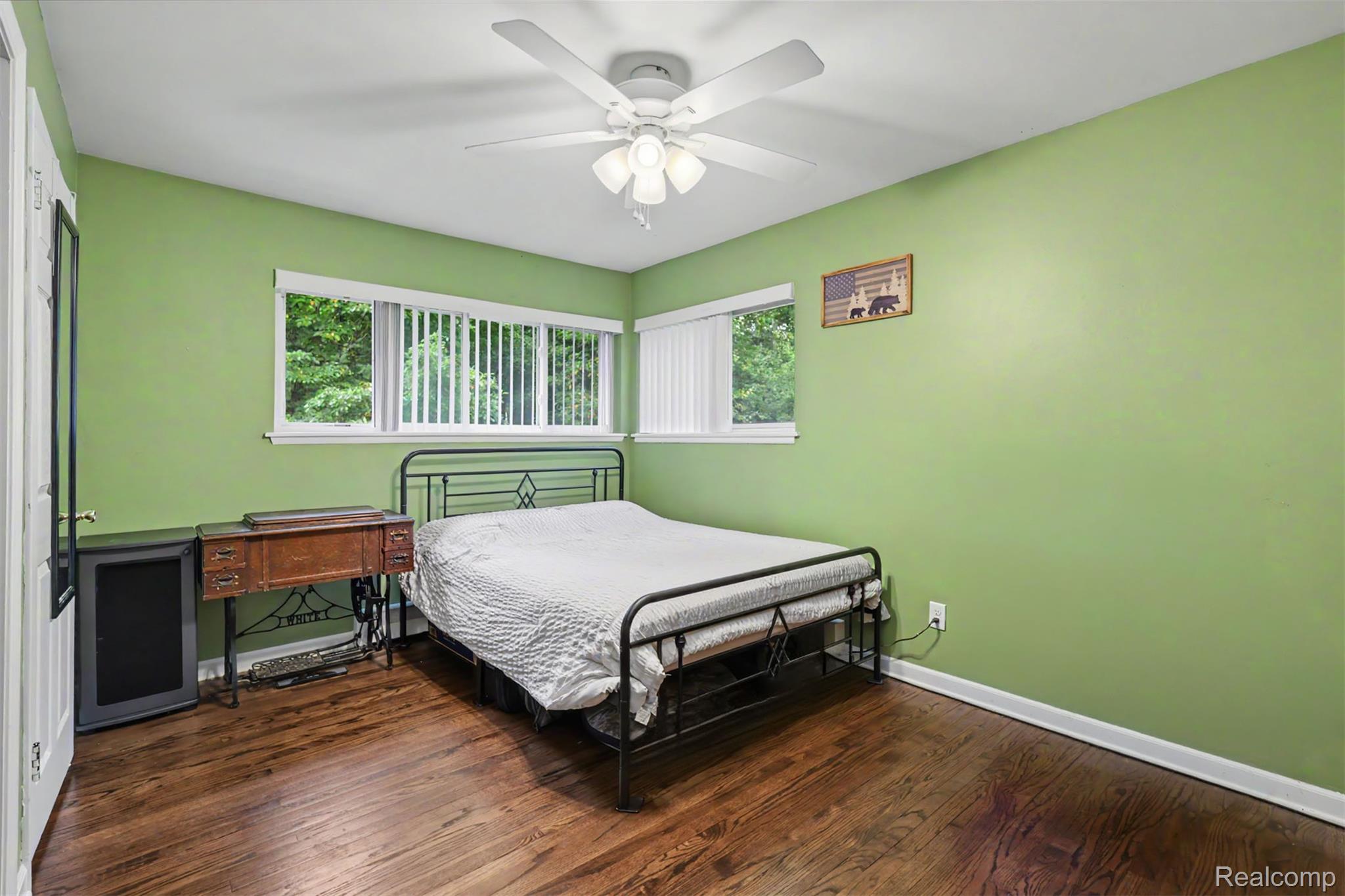 45223 Wear Road Belleville, MI 48111 - Photo 41 of 60 Rich wood-finish flooring, multiple windows providing natural light, and a ceiling fan with integrated lighting