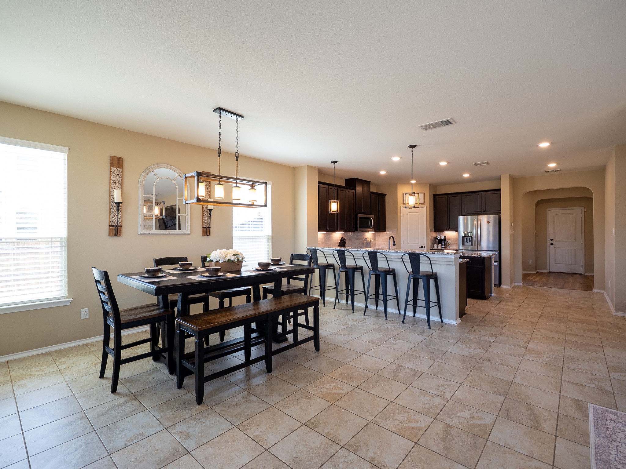104 Rocroi Drive Georgetown, TX 78626 - Photo 6 of 40 An open dining area and adjacent kitchen feature tile flooring and clean architectural lines.