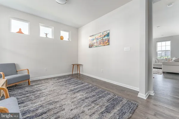 a living room with a mirror and a table