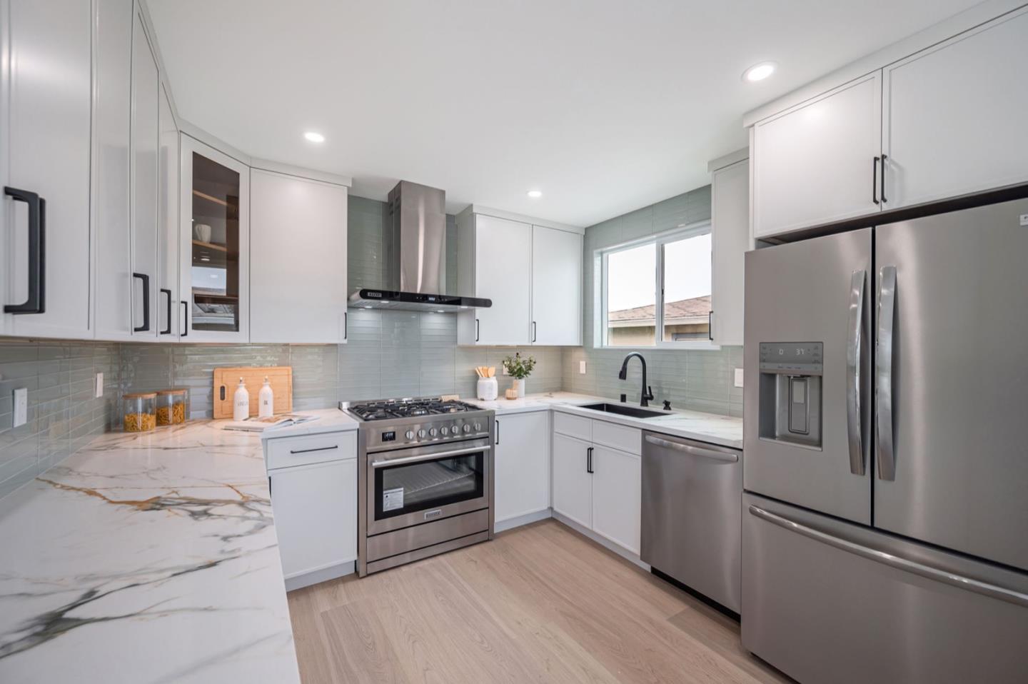 443 Andover Drive Pacifica, CA 94044 - Photo 15 of 56 a kitchen with stainless steel appliances granite countertop a refrigerator sink and stove
