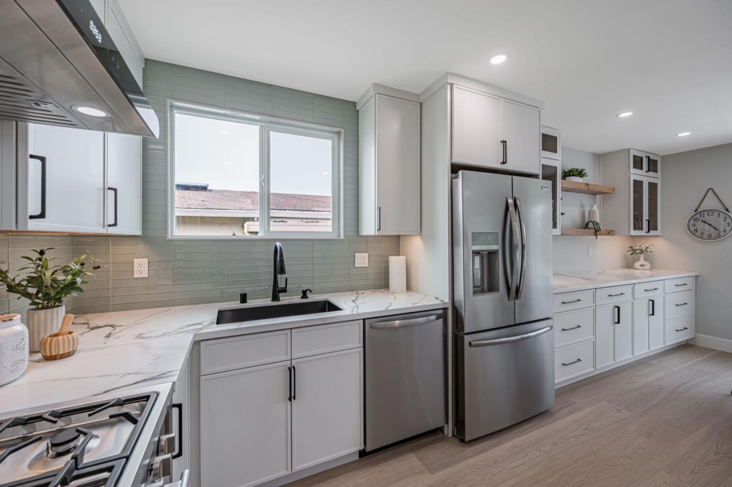 443 Andover Drive Pacifica, CA 94044 - Photo 16 of 56 a kitchen with white cabinets sink and refrigerator
