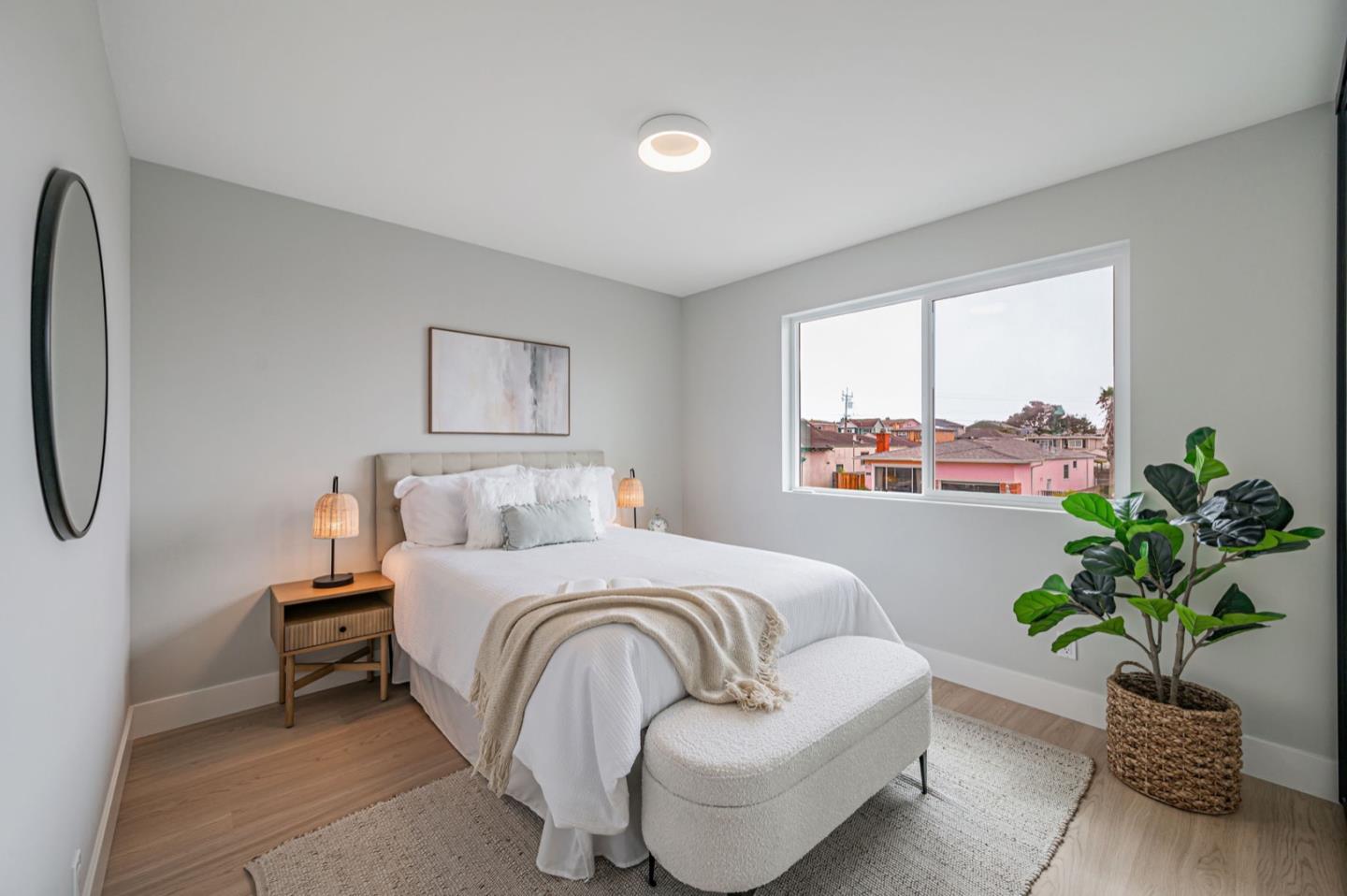 443 Andover Drive Pacifica, CA 94044 - Photo 27 of 56 a bedroom with a bed and a potted plant
