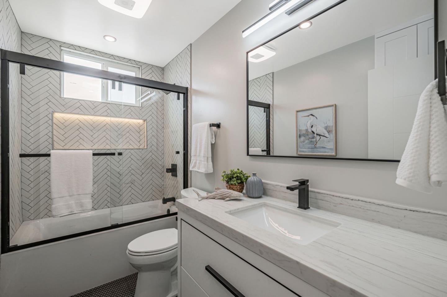 443 Andover Drive Pacifica, CA 94044 - Photo 32 of 56 a bathroom with a sink mirror toilet and shower