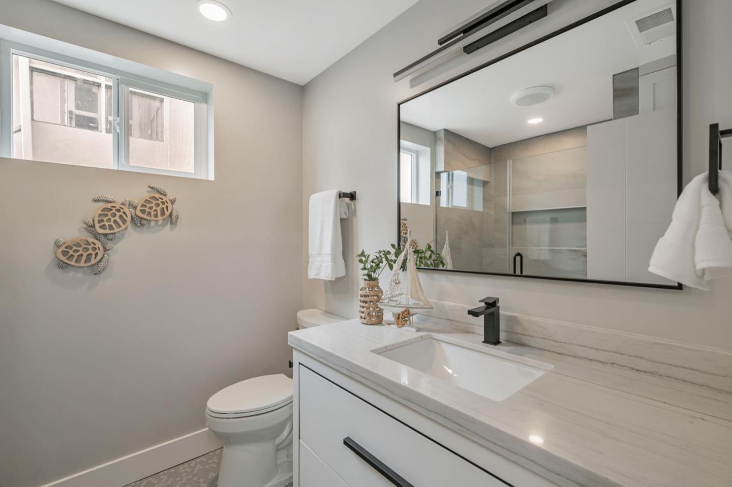 443 Andover Drive Pacifica, CA 94044 - Photo 33 of 56 a bathroom with a granite countertop sink mirror vanity and toilet