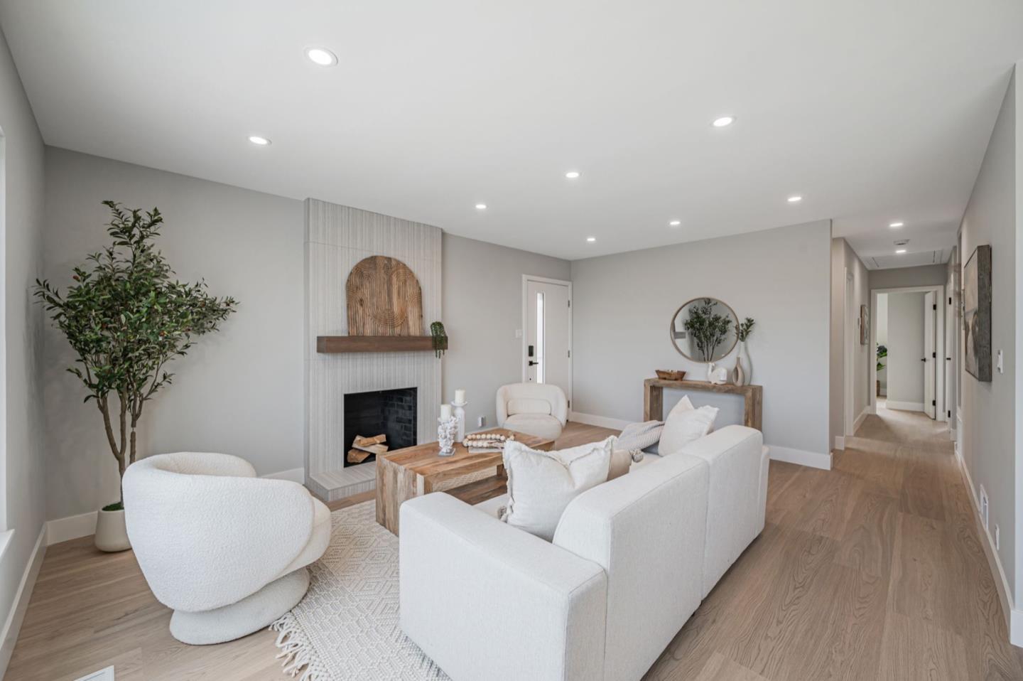 443 Andover Drive Pacifica, CA 94044 - Photo 8 of 56 a living room with furniture a fireplace and a potted plant