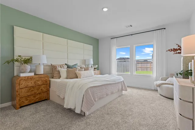 a spacious bedroom with a bed and window