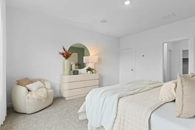 a bedroom with bed and a couch