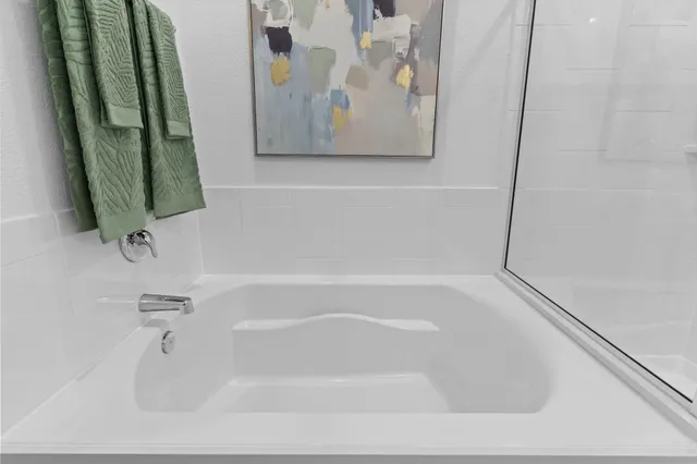 a white bath tub sitting next to a white sink