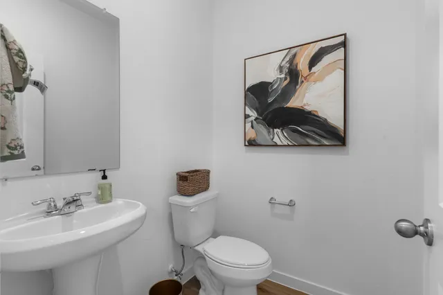 a bathroom with a toilet sink and mirror