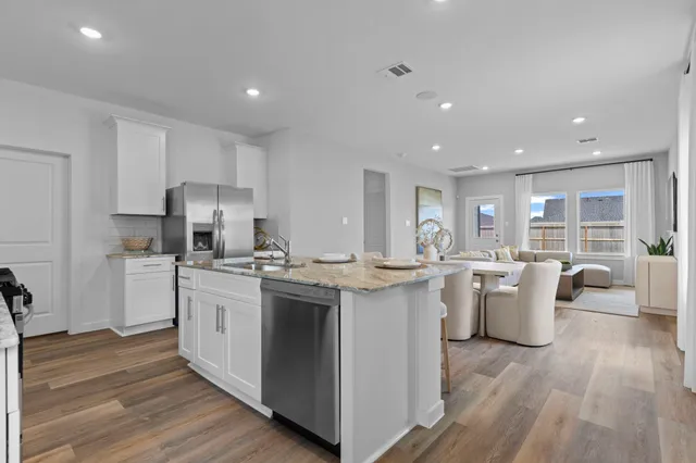 a kitchen with a sink stove and wooden cabinets