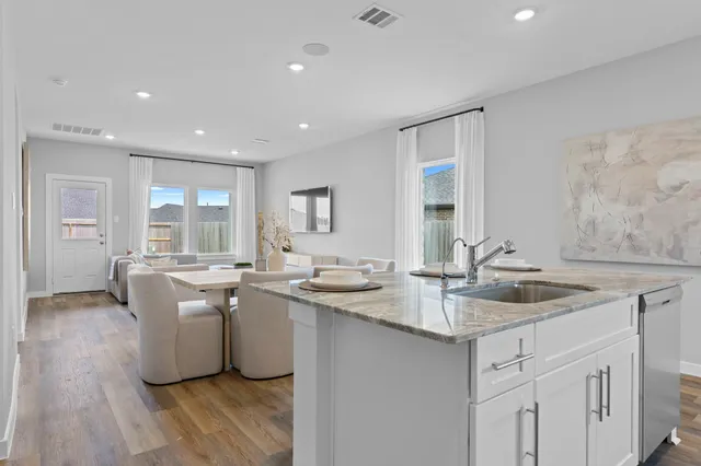 a kitchen with sink stove and cabinets