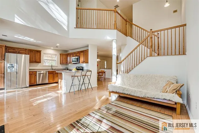 a living room with wooden floor and a rug
