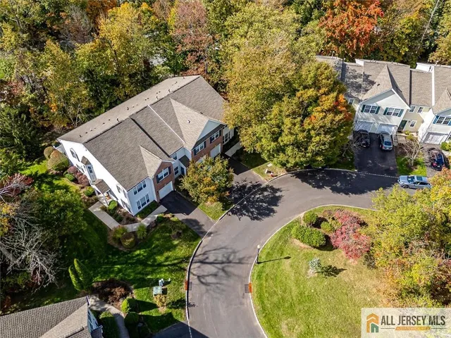 an aerial view of a house with a yard and trees