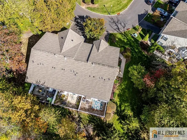 an aerial view of a house with a yard and garden