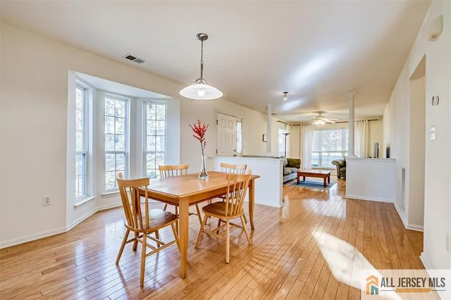 a view of a dining room with furniture window and wooden floor