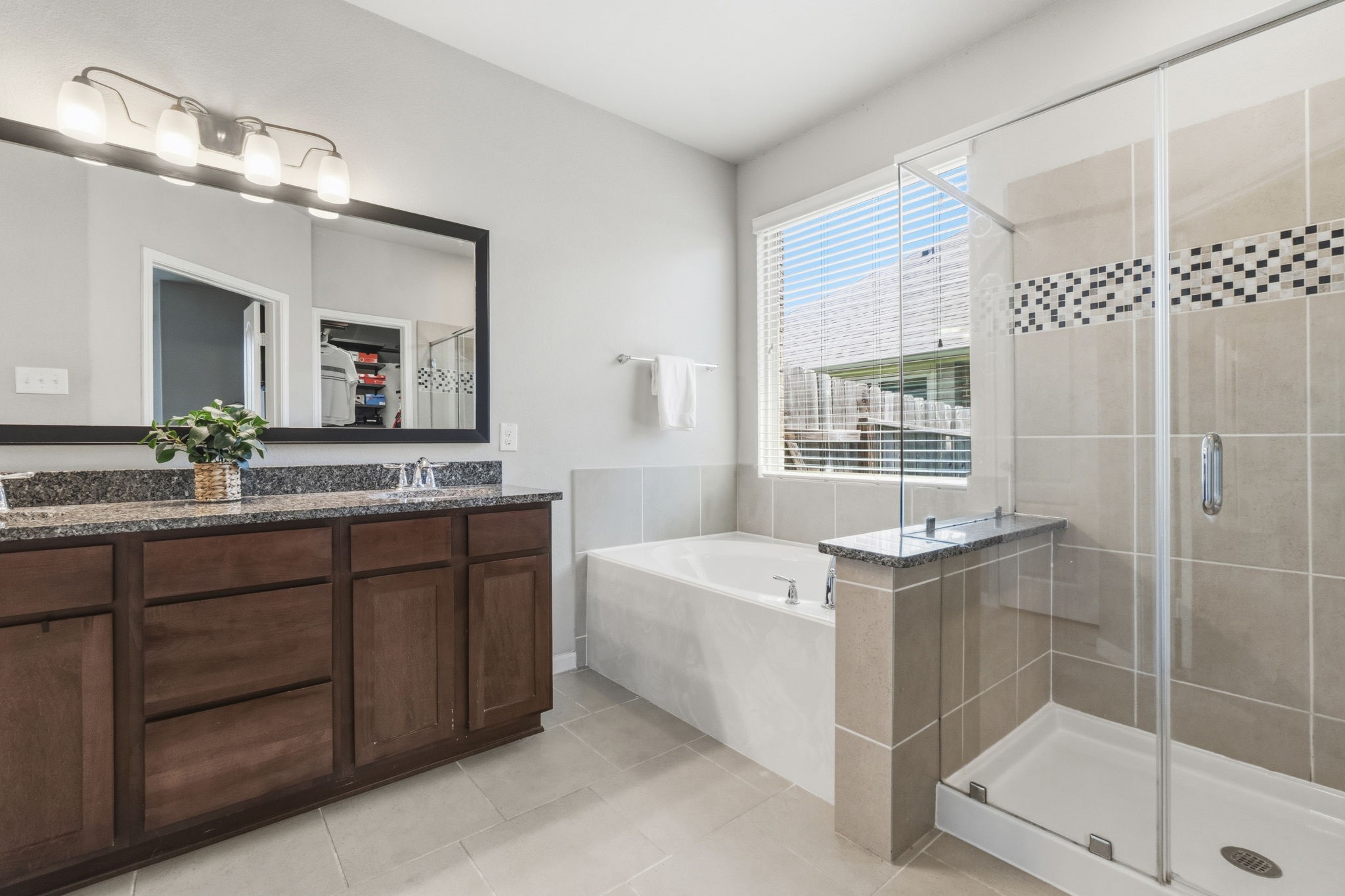 3900 Enchanted Timbers Lane Spring, TX 77386 - Photo 22 of 49 a bathroom with a tub sink and mirror