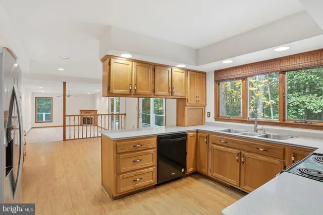 a view of a kitchen with furniture and wooden floor