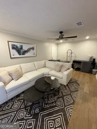 a living room with furniture and a rug