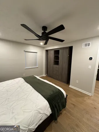 a bedroom with a bed and a mirror