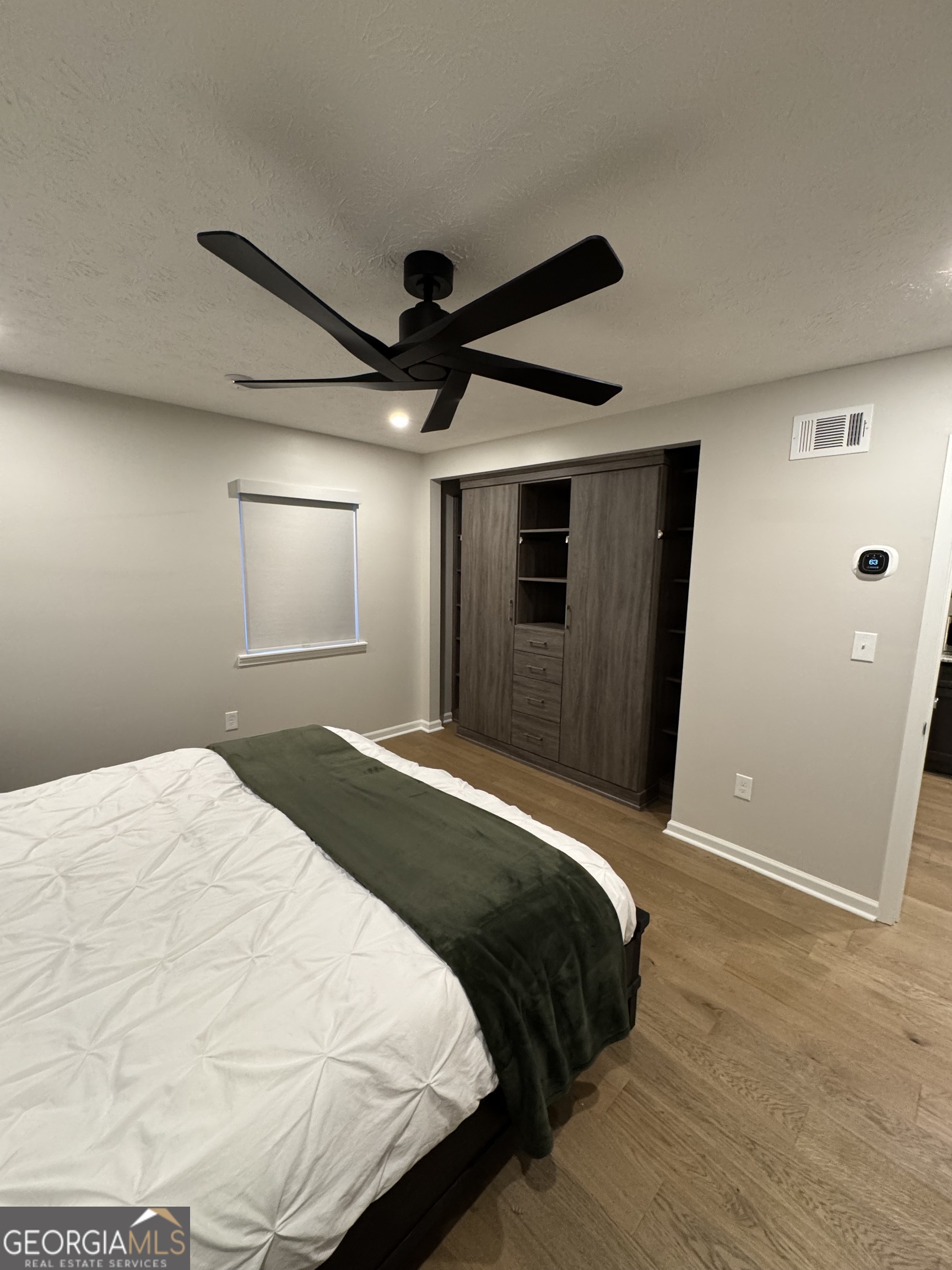 174 Talmadge Street, Unit 14 Athens, GA 30605 - Photo 3 of 11 a bedroom with a bed and a mirror