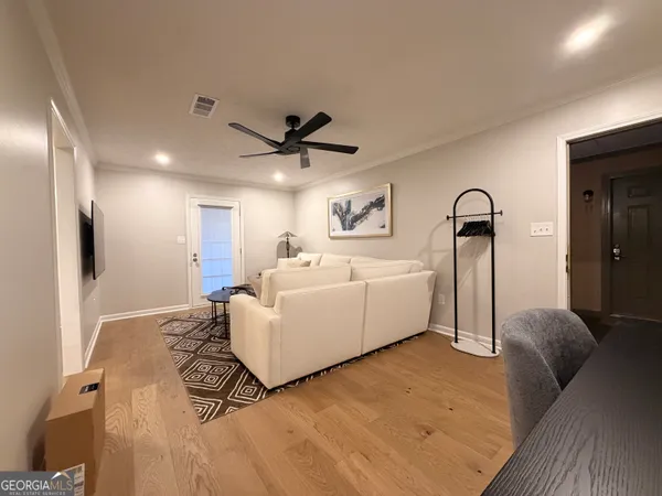 a living room with furniture and a large window