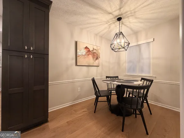a view of a dining room with furniture window and wooden floor