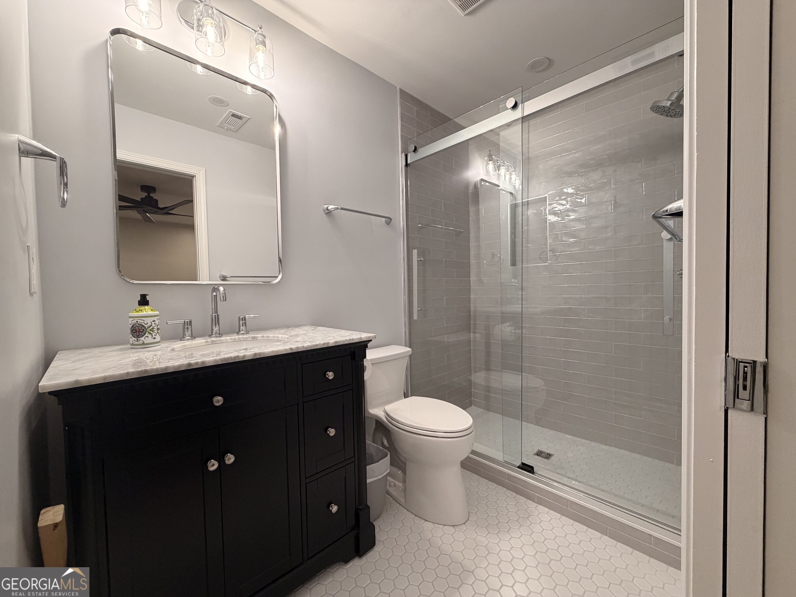 174 Talmadge Street, Unit 14 Athens, GA 30605 - Photo 9 of 11 a bathroom with a double vanity sink toilet and shower