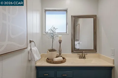 a bathroom with a double vanity sink and a mirror