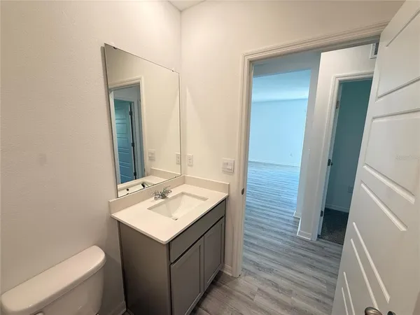 a bathroom with a sink toilet and mirror