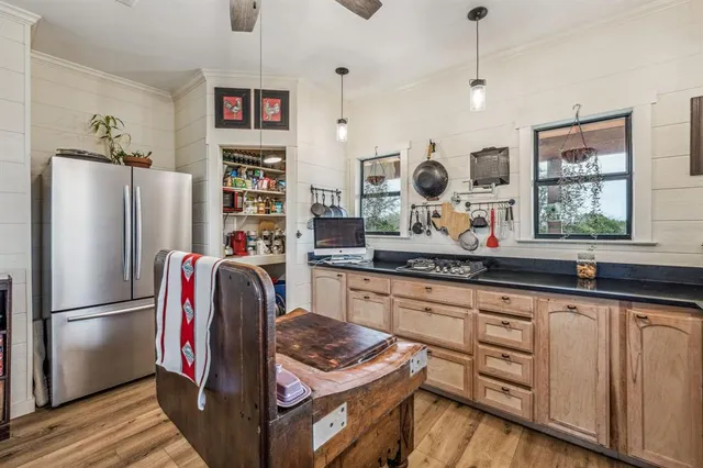 a kitchen with stainless steel appliances granite countertop a refrigerator and a sink