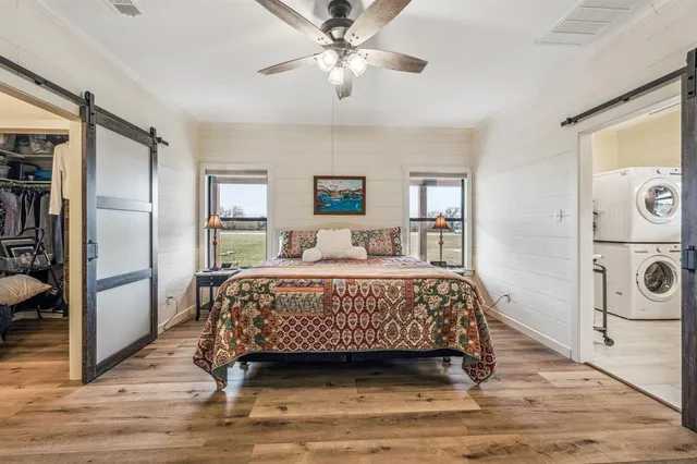 a bedroom with a bed and a refrigerator