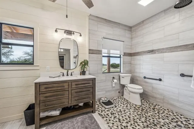 a bathroom with a sink toilet and shower