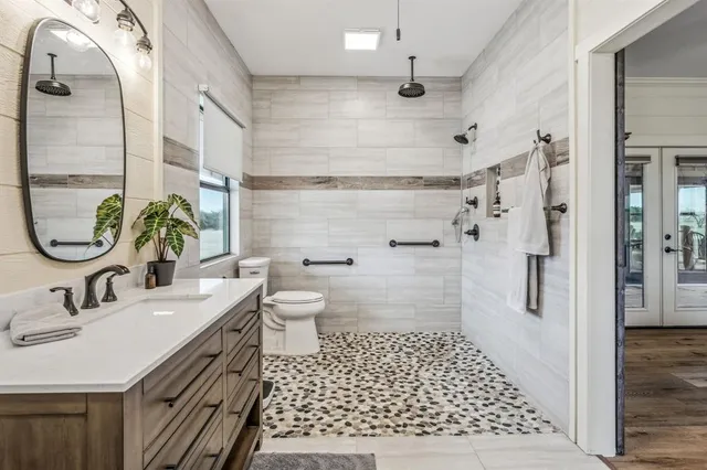 a bathroom with a sink toilet and shower