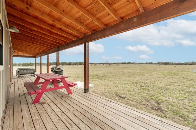 a view of a balcony with wooden floor